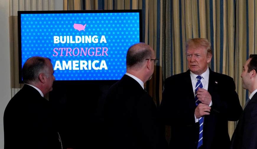 Click to enlarge U.S. President Donald Trump speaks to attendees as he departs his infrastructure initiative meeting at the White House in Washington Monday.
