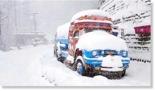 A vehicle covered in snow in Nathiagali Bazaar area of Abbottabad.