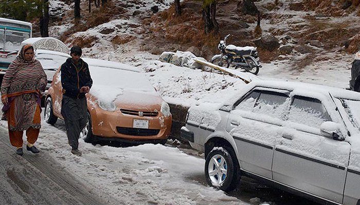 Vehicles covered in snow in Murree.
