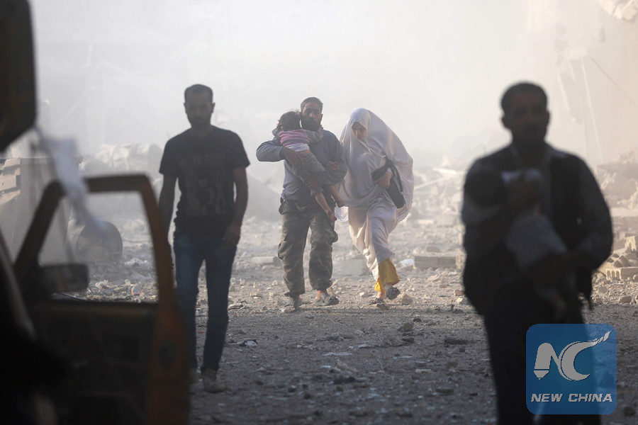 Click to enlarge Syrians emerge from a dust cloud