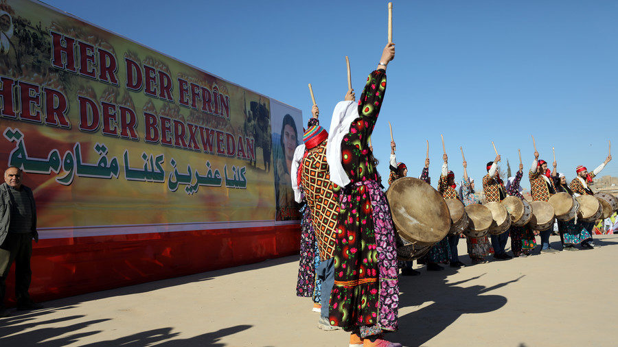 Kurds dance during a protest