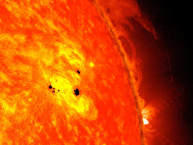 These two large black spots on the sun, known as sunspots, appeared quickly in February 2013, and each is as wide across as six Earths.