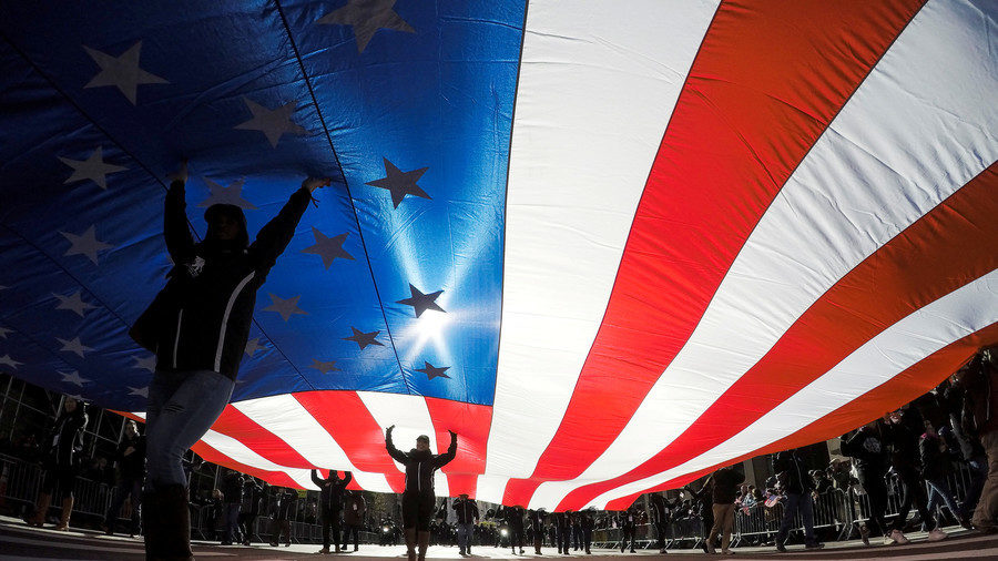 People carry the U.S. flag