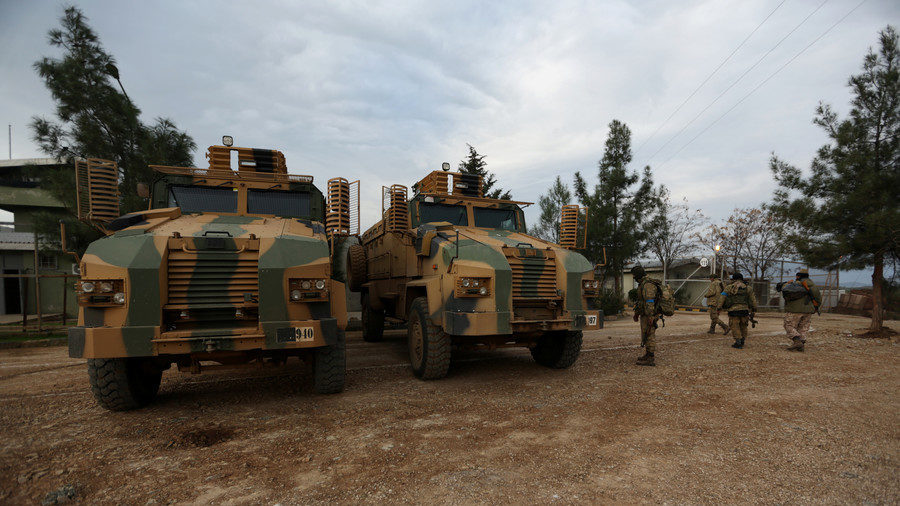 Turkish-backed Free Syrian Army fighters are seen next to military trucks