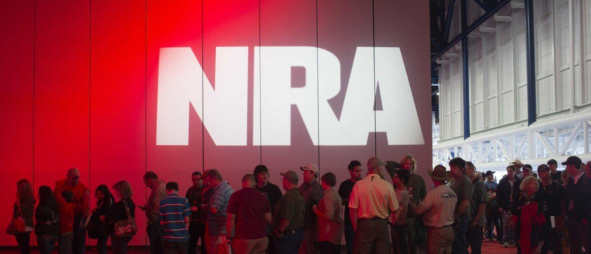 Click to enlarge NRA attendees line-up to meet musician Ted Nugent