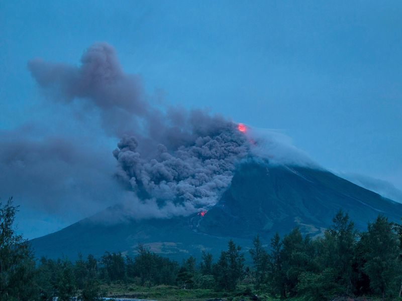 Lava cascades down the slopes of the erupting Mayon volcano in January 2018. Seen from Busay Village in Albay province, 210 miles southeast of Manila, Philippines.
