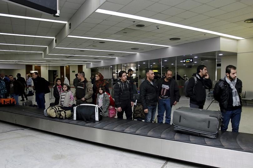 Iraqi refugees voluntarily returning from Finland, wait for their luggage at Baghdad airport, Iraq February 18, 2016.