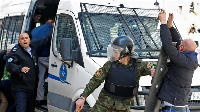 Click to enlarge Palestinian police prevent demonstrators from approaching a police vehicle