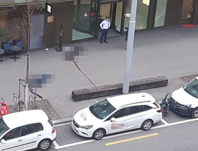 Click to enlarge A police operation is underway in Zurich after two people were shot dead outside a bank. Pictures have emerged of what appear to be two bodies lying on the ground outside a branch of UBS
