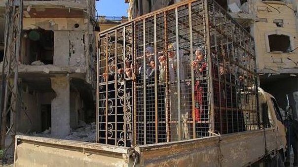 Click to enlarge Women in cage used as human shields