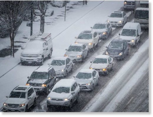 Motorists sit in traffic as snow falls in Vancouver, B.C., on Friday February 23, 2018. Environment Canada issued a snowfall warning for Metro Vancouver with 10 to 20 centimetres of snow expected.