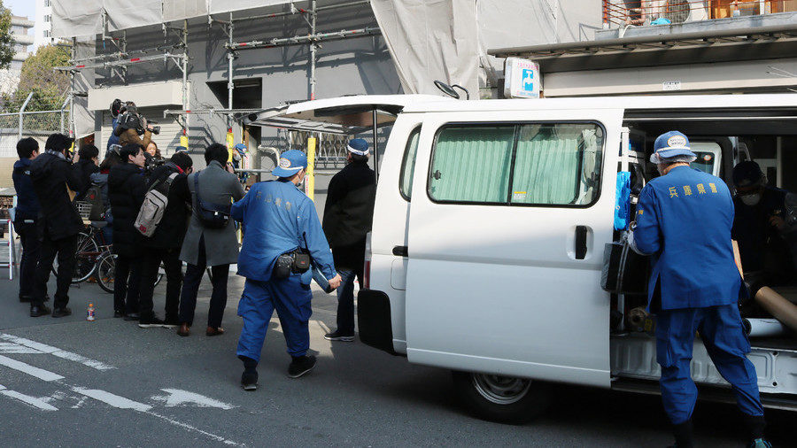 Hyogo prefectural police at the apartment where the decapitated head was found.