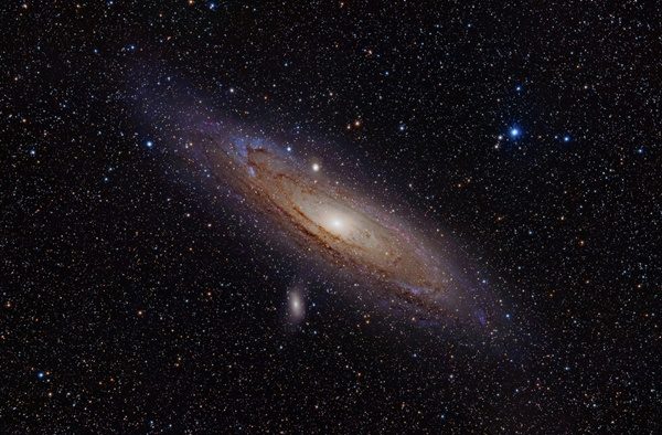 Click to enlarge The Andromeda Galaxy, along with two of its satellites: M110 can be seen below the plane, and M32 as the small, round object just above it.