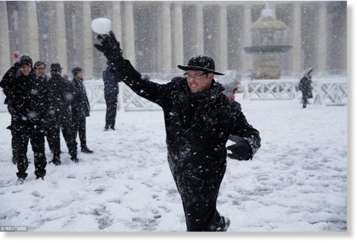 A young priest throws a snowball at others in St. Peter's Square at the Vatican after Rome woke to several inches of snow