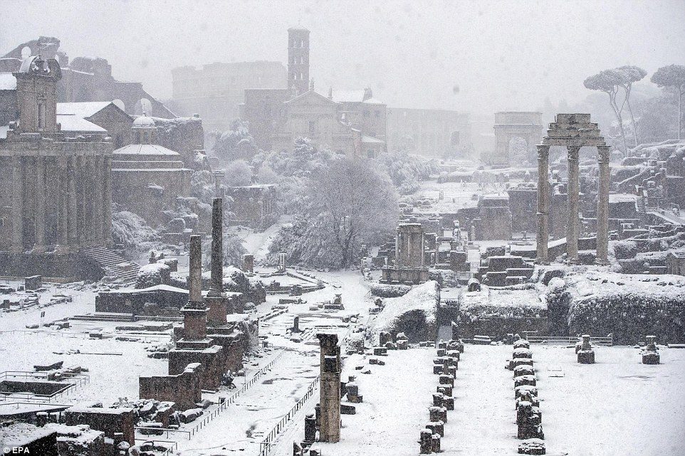 The Fori Imperiali, once the centre of the Roman Empire, is seen covered by snow in Rome on Monday morning