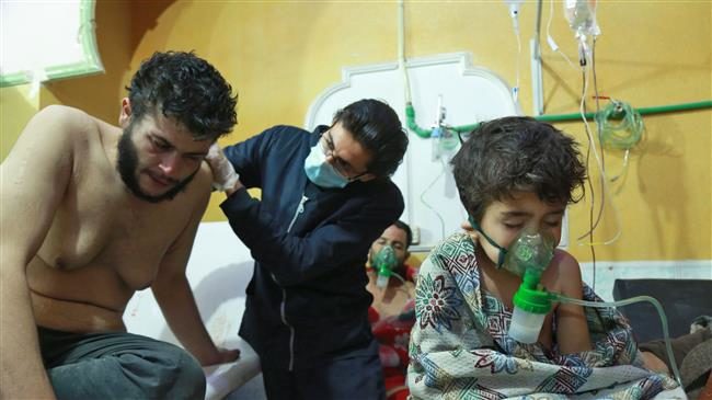 Click to enlarge Syrian children and adults receive treatment for a suspected chemical attack at a makeshift clinic