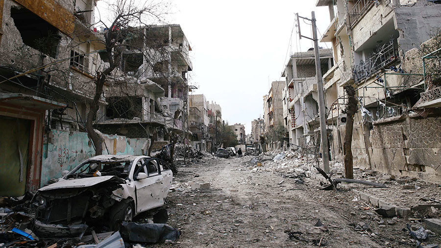 Damaged cars and buildings are seen in the besieged town of Douma, Eastern Ghouta