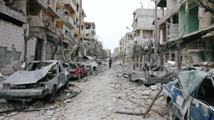 Click to enlarge The damaged cars and buildings are seen in the besieged town of Douma
