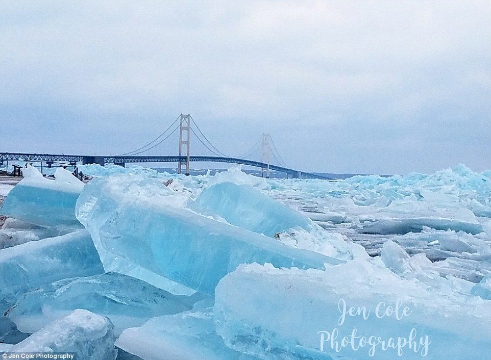 Click to enlarge Stunning photographs have capture the epic natural phenomenon known as blue ice forming on Michigan's upper and lower peninsulas