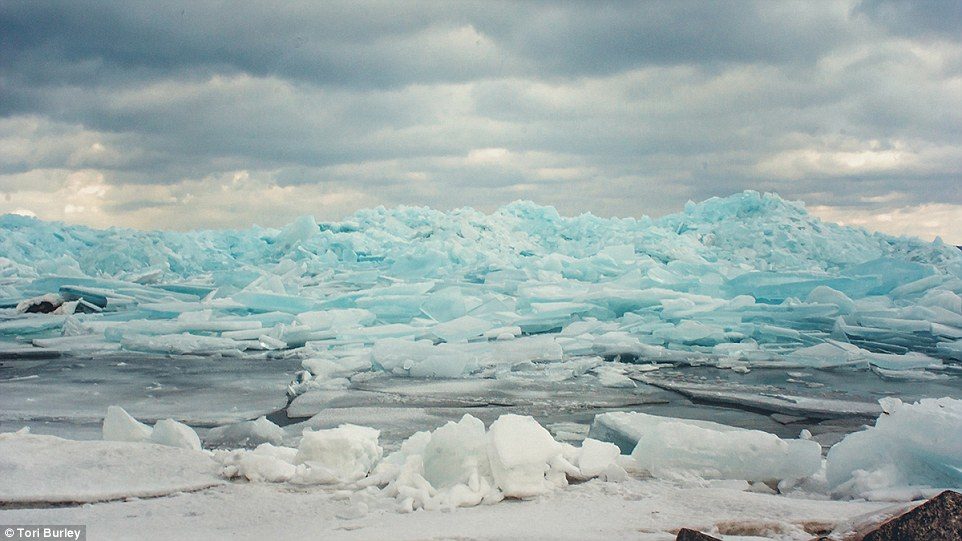 'We grabbed our cameras and took a hike out on the ice to explore,' Caverly told the Press. 'The ice had piled up and there were great views everywhere'
