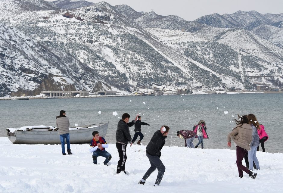 Children played in the snow at a park in Pogradec, in southeast Albania, on Tuesday.