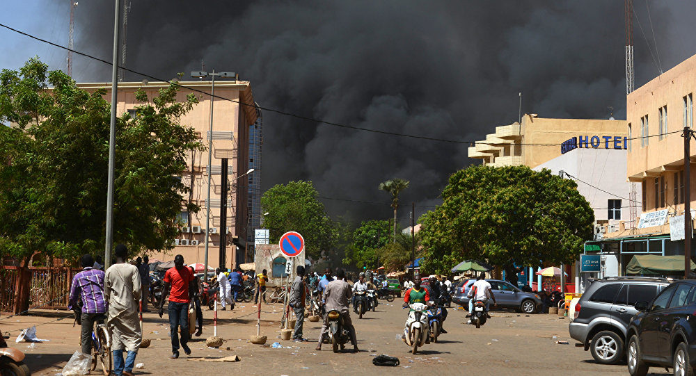 Click to enlarge People watch as black smoke rises