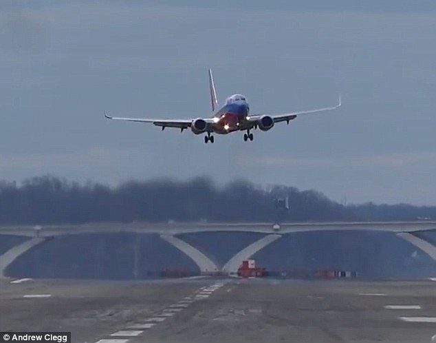 Click to enlarge Flights full of vomiting passengers have been landing in Washington DC, while the powerful winds meant some planes weren't able to land at all (pictured, a plane was swaying so violently, the pilot decided to pull out of the landing)