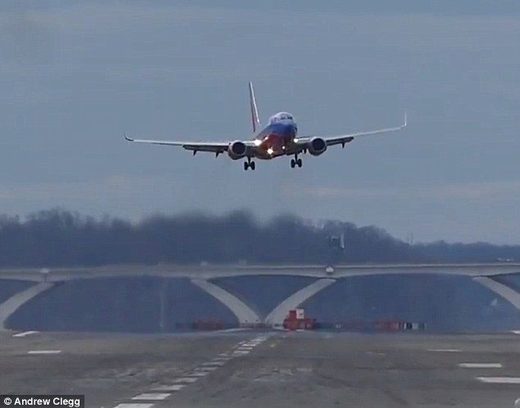 Flights full of vomiting passengers have been landing in Washington DC, while the powerful winds meant some planes weren't able to land at all (pictured, a plane was swaying so violently, the pilot decided to pull out of the landing)