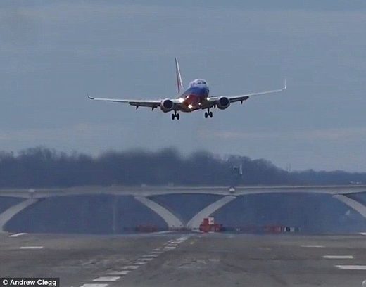 Click to enlarge Flights full of vomiting passengers have been landing in Washington DC, while the powerful winds meant some planes weren't able to land at all (pictured, a plane was swaying so violently, the pilot decided to pull out of the landing)