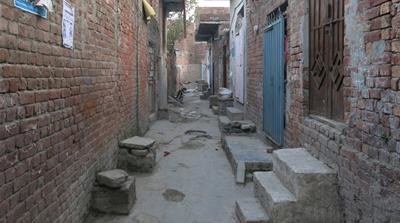 Click to enlarge A view of the street on which Patras Masih lives
