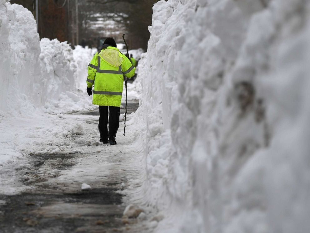 A farmer makes her way through heavy snow in Blessington, Ireland