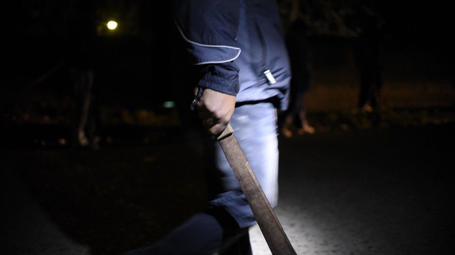 Click to enlarge A man armed with a machete.