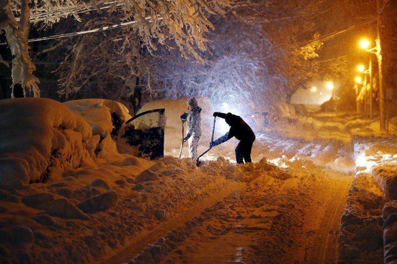 A resident digs out their car after a snowstorm dumped over a foot of snow