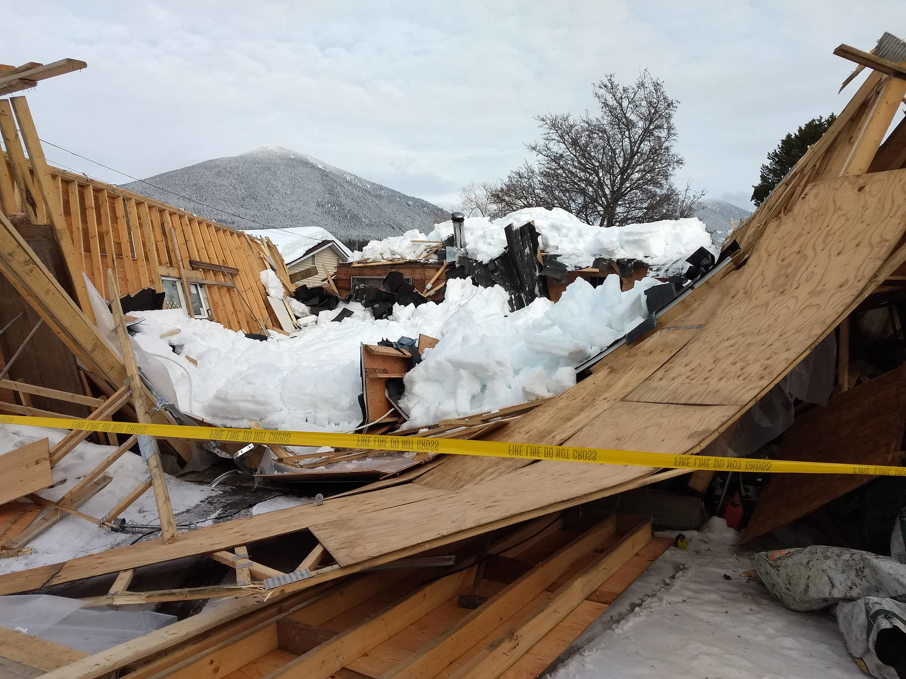 Click to enlarge The walls of the back of the garage are blown outward, completely destroying the structure.