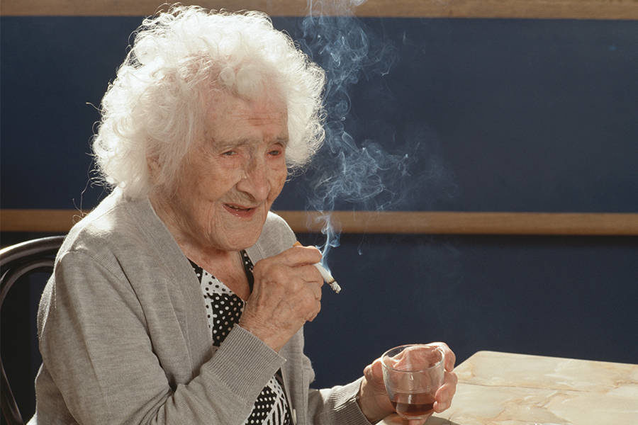 Click to enlarge Jeanne Calment, smoking a cigarette.