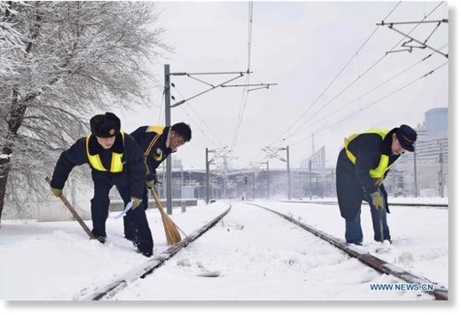 Click to enlarge Workers remove snow from train tracks at Shenyang North Railway Station in Shenyang, northeast China's Liaoning province, March 15, 2018.