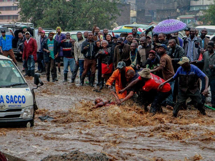 A passenger is rescued from a submerging Matatu along Grogon area Near Kirinyaga road following heavy down pour witnessed in Nairobi and its Outskirts on March 15,2018.