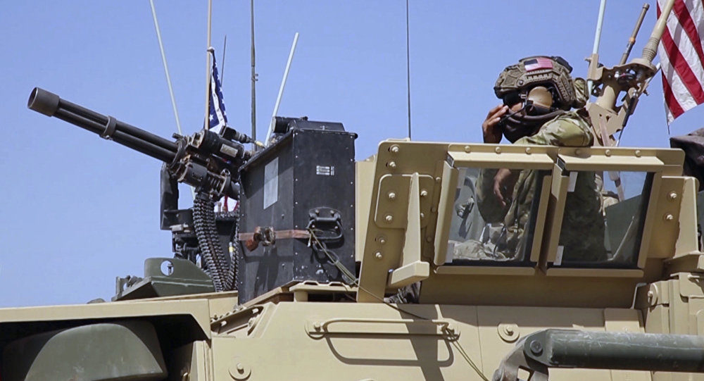 Click to enlarge American soldier looking out of an armored vehicle