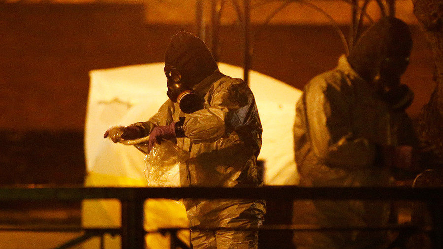 Members of the emergency services wearing protective clothing work near the bench where former Russian intelligence officer Sergei Skripal and his daughter Yulia were found poisoned in Salisbury, Britain, March 13, 2018. 