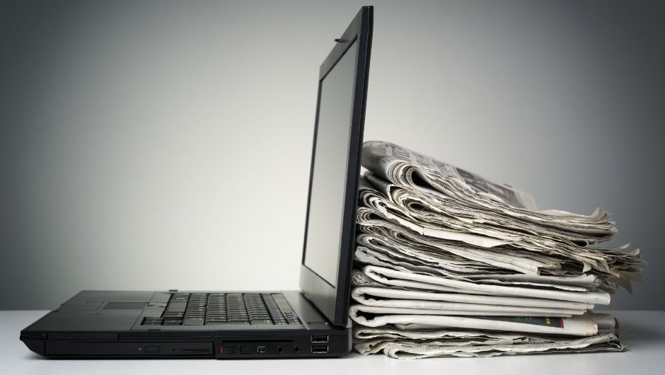 Click to enlarge laptop newspapers