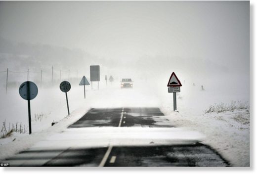 A car travels along a road covered by the snow near to Santa Cruz de Campezo, northern Spain, after the country was dusted with the white stuff