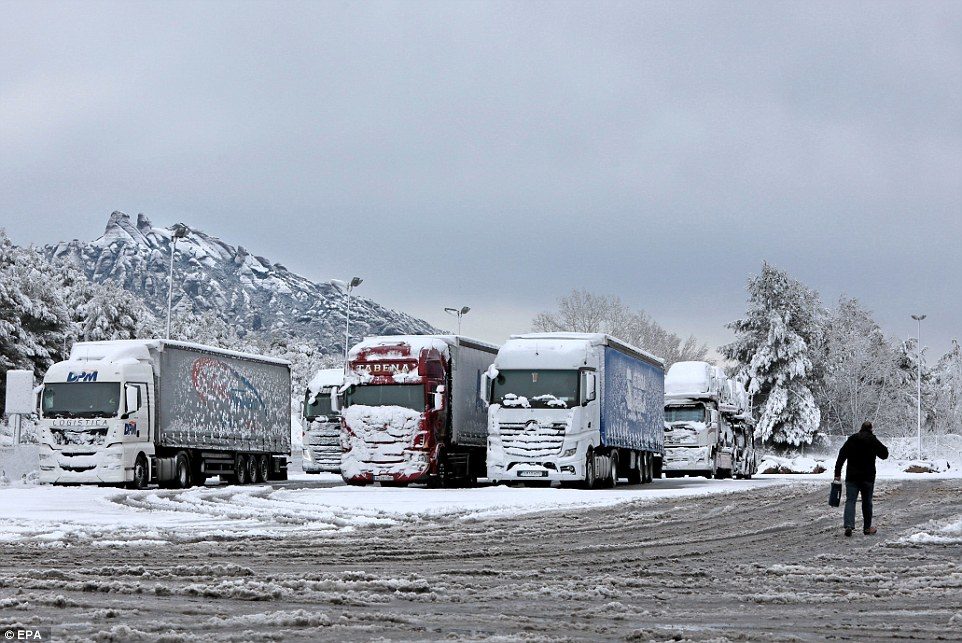 Trucks are detained at Coll del Bruc in Barcelona, Spain, 20 March 2018, as they wait for traffic to reestablish after a snowfall
