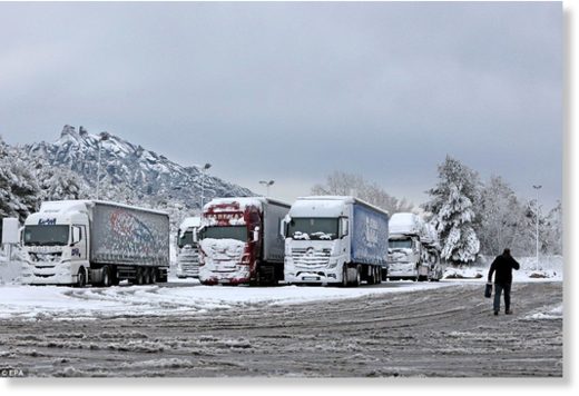 Trucks are detained at Coll del Bruc in Barcelona, Spain, 20 March 2018, as they wait for traffic to reestablish after a snowfall