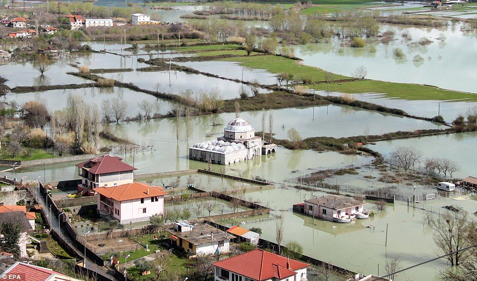 Click to enlarge After flooding in Albania, a mosque can be seen submerged by water near Shkoder, alongside other waterlogged properties