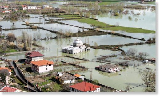 After flooding in Albania, a mosque can be seen submerged by water near Shkoder, alongside other waterlogged properties