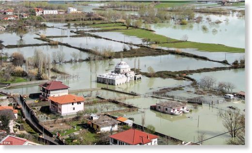 Click to enlarge After flooding in Albania, a mosque can be seen submerged by water near Shkoder, alongside other waterlogged properties
