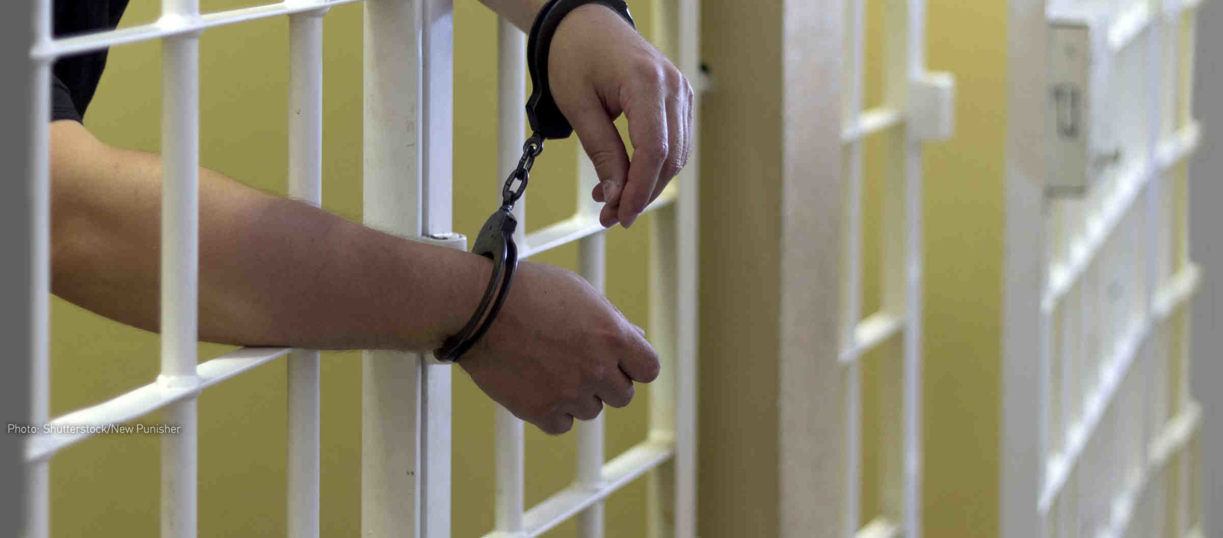 Click to enlarge Shackled man in prison