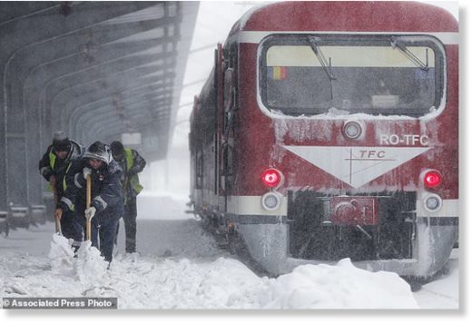 Click to enlarge Municipal workers clear ice and snow from the platforms of the Gara de Nord, the main railway station in Bucharest, Romania, Friday, March 23, 2018.