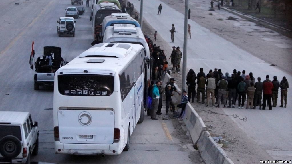 Rebel fighters are evacuated from the city of Harasta