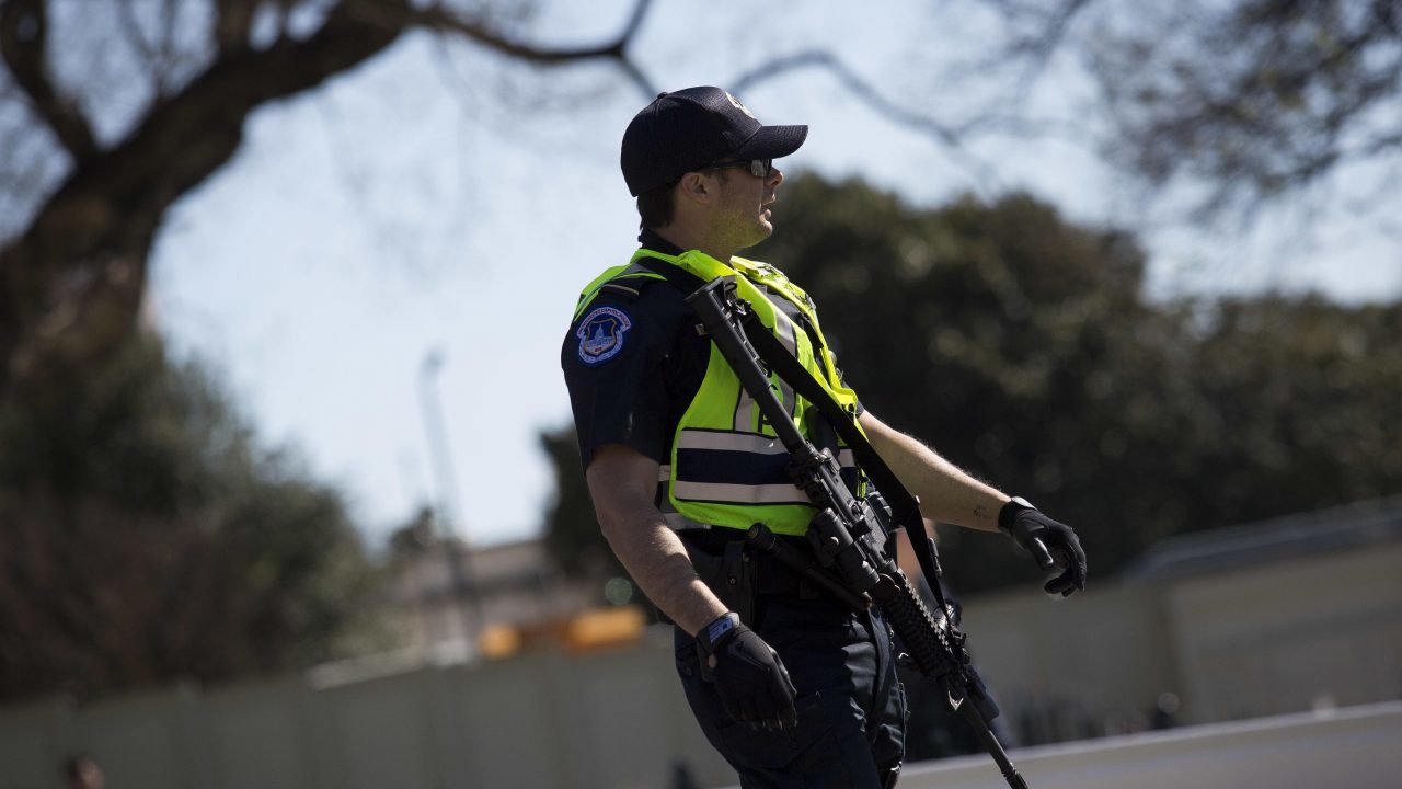Click to enlarge armed police officers protect anti gun rally
